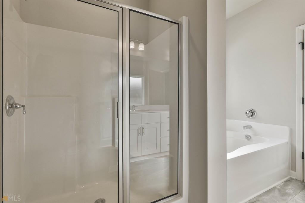 124 Willington Way Newnan, GA 30265 - Photo 17 of 41 a bathroom with a bathtub and shower