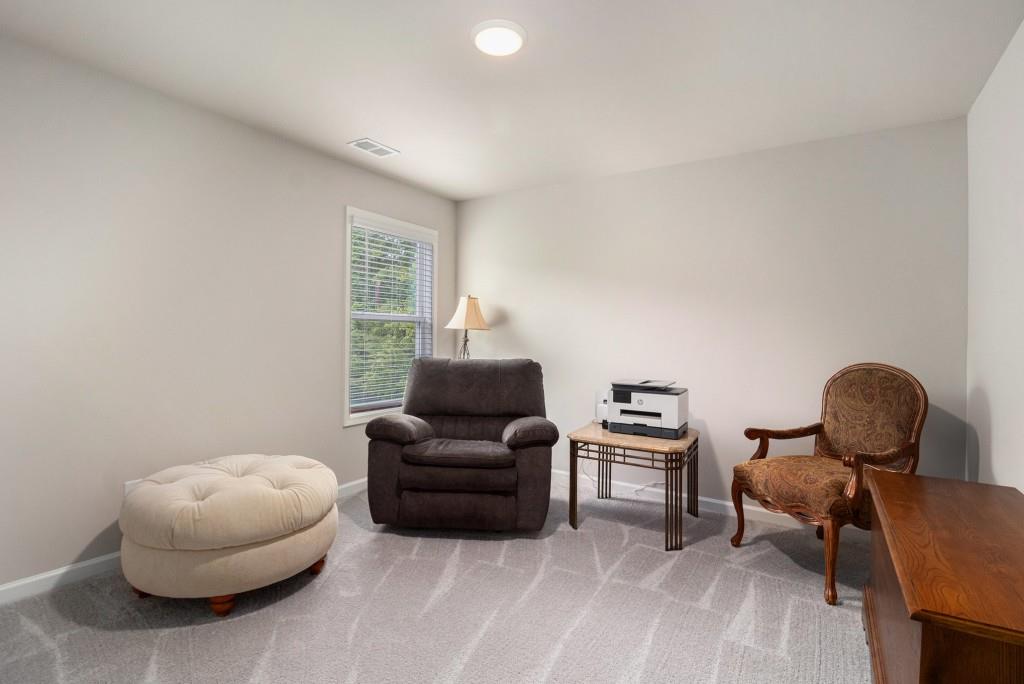 124 Willington Way Newnan, GA 30265 - Photo 19 of 41 a living room with furniture and a chair