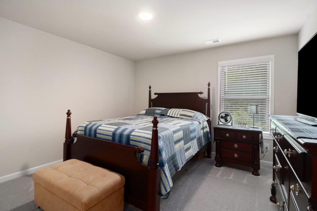 124 Willington Way Newnan, GA 30265 - Photo 20 of 41 a bedroom with a bed and a window