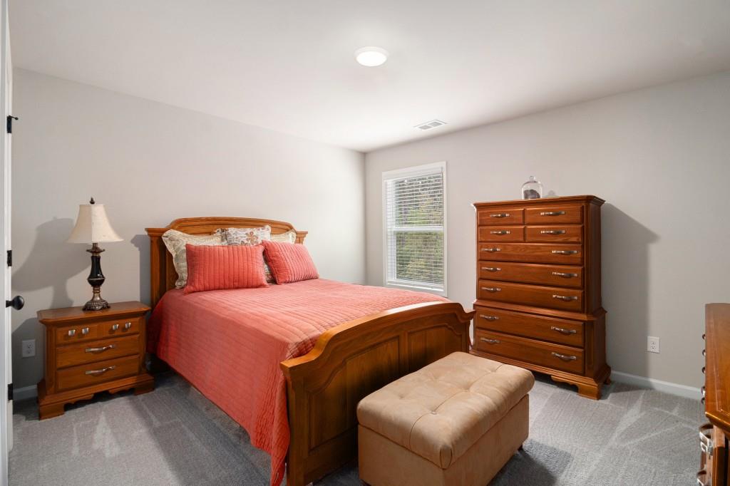 124 Willington Way Newnan, GA 30265 - Photo 21 of 41 a bedroom with a bed and a dresser