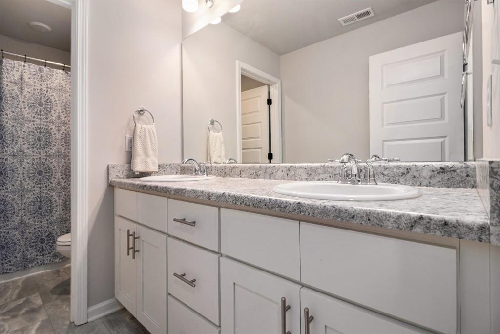 124 Willington Way Newnan, GA 30265 - Photo 22 of 41 a bathroom with a granite countertop sink and a mirror