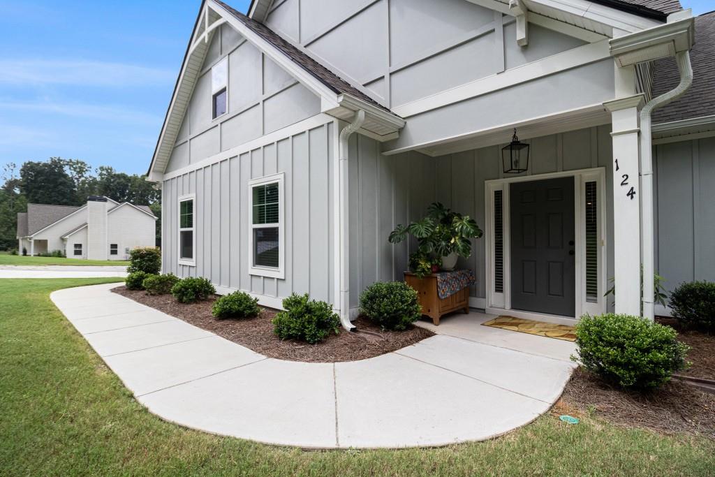 124 Willington Way Newnan, GA 30265 - Photo 28 of 41 a view of a white house next to a yard