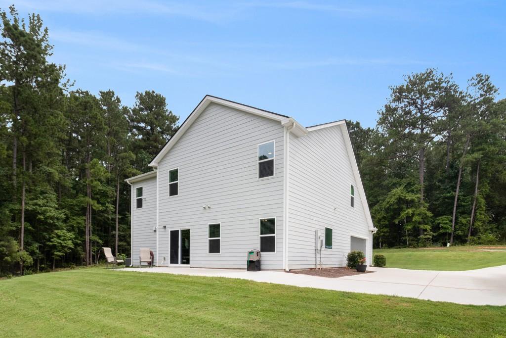 124 Willington Way Newnan, GA 30265 - Photo 30 of 41 a view of a white house with a yard