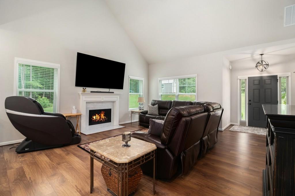 124 Willington Way Newnan, GA 30265 - Photo 3 of 41 a living room with furniture a fireplace and a flat screen tv