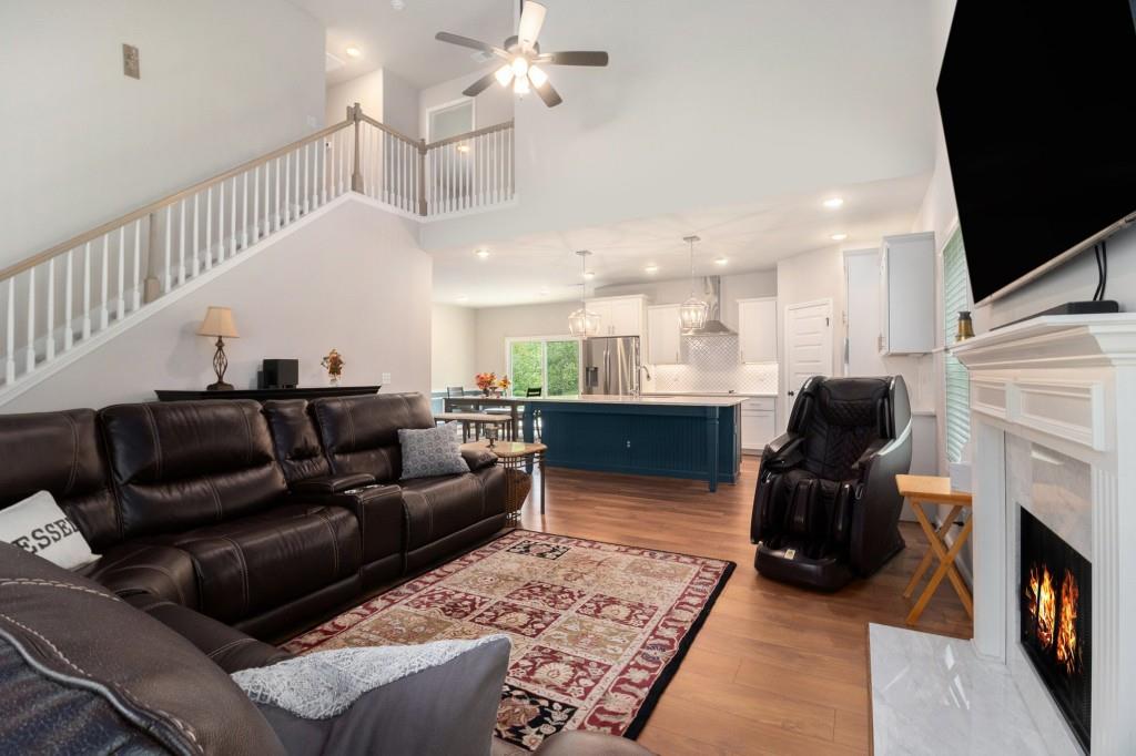 124 Willington Way Newnan, GA 30265 - Photo 5 of 41 a living room with furniture a fireplace and a flat screen tv