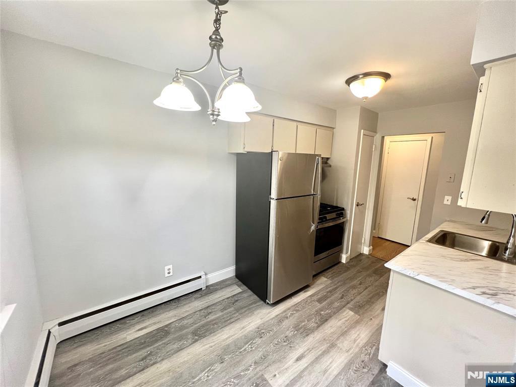 15-1 Spruce Street, Unit 151 Oakland, NJ 07436 - Photo 5 of 13 a kitchen with granite countertop a refrigerator and microwave