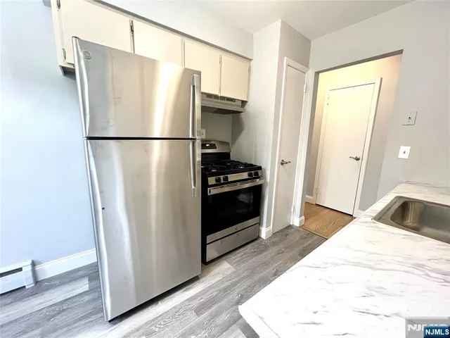 a kitchen with a refrigerator and a sink