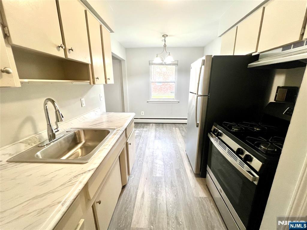 15-1 Spruce Street, Unit 151 Oakland, NJ 07436 - Photo 7 of 13 a kitchen with granite countertop a refrigerator stove and sink