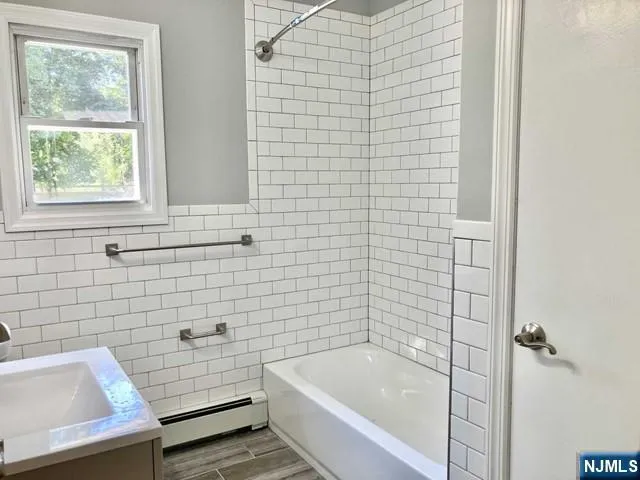 a bathroom with a bathtub and shower