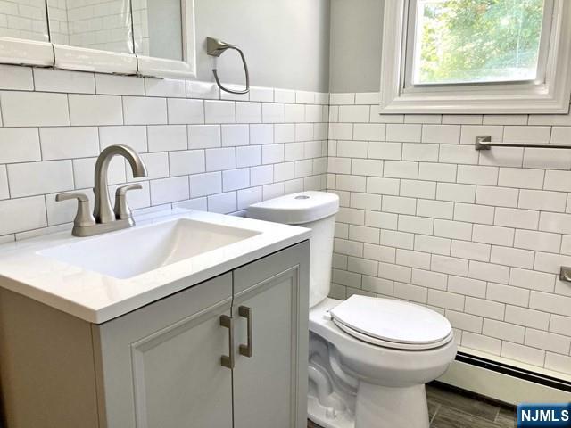 15-1 Spruce Street, Unit 151 Oakland, NJ 07436 - Photo 9 of 13 a bathroom with a sink a toilet and a mirror