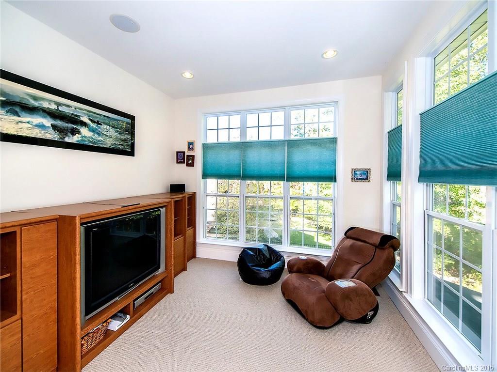 4415 Sunset Rose Drive Fort Mill, SC 29708 - Photo 10 of 24 a living room with furniture a flat screen tv and a large window