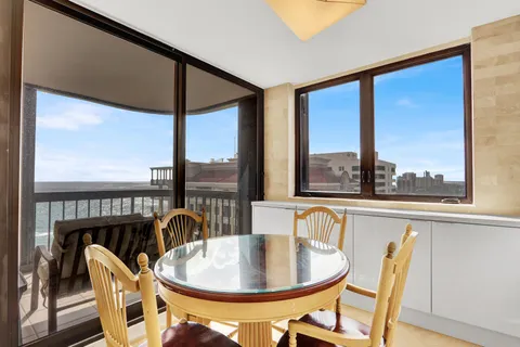 a dining room with furniture window and outside view