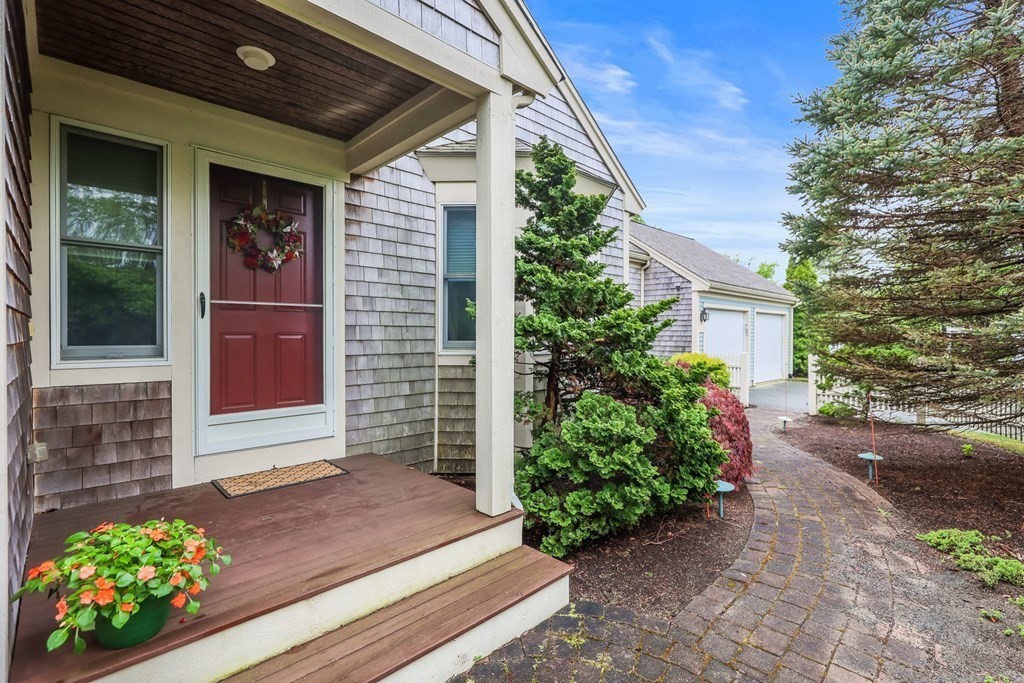 2 Sampson Cmns, Unit 2 Plymouth, MA 02360 - Photo 1 of 31 a front view of a house with a garden