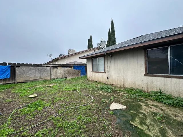 a backyard of a house with lots of green space and porch