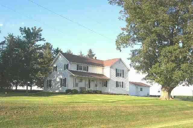 13900 West Howardsville Road Lena, IL 61048 - Photo 1 of 9 a front view of a house with a garden and trees