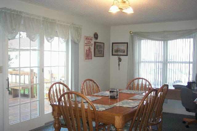 13900 West Howardsville Road Lena, IL 61048 - Photo 4 of 9 a view of a a dining room with furniture window and outside view