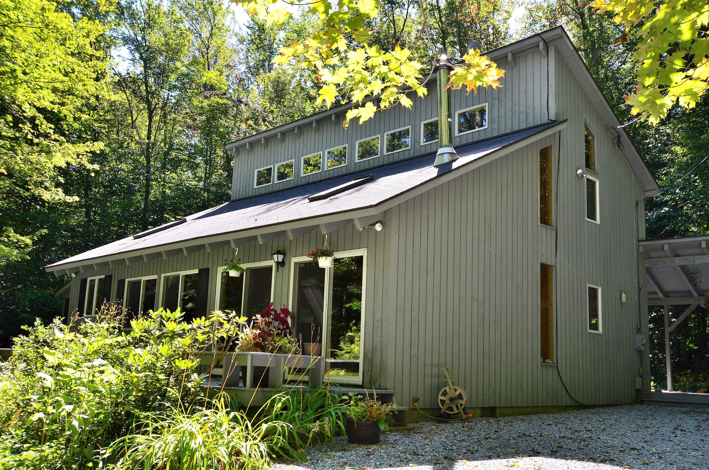 19 Cherokee Road Becket, MA 01223 - Photo 1 of 22 a front view of a house with garden