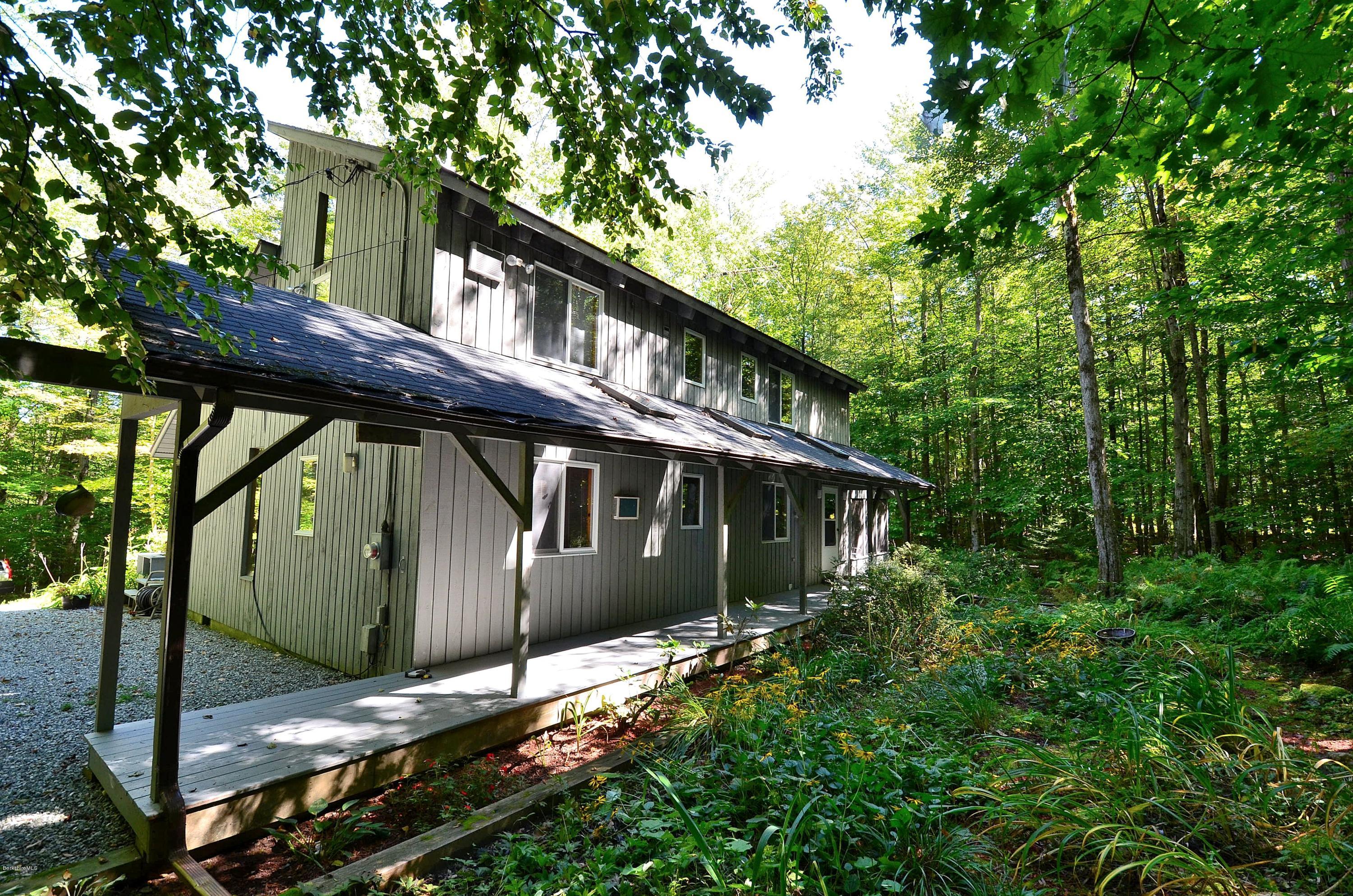 19 Cherokee Road Becket, MA 01223 - Photo 2 of 22 a view of house with large windows and a tree