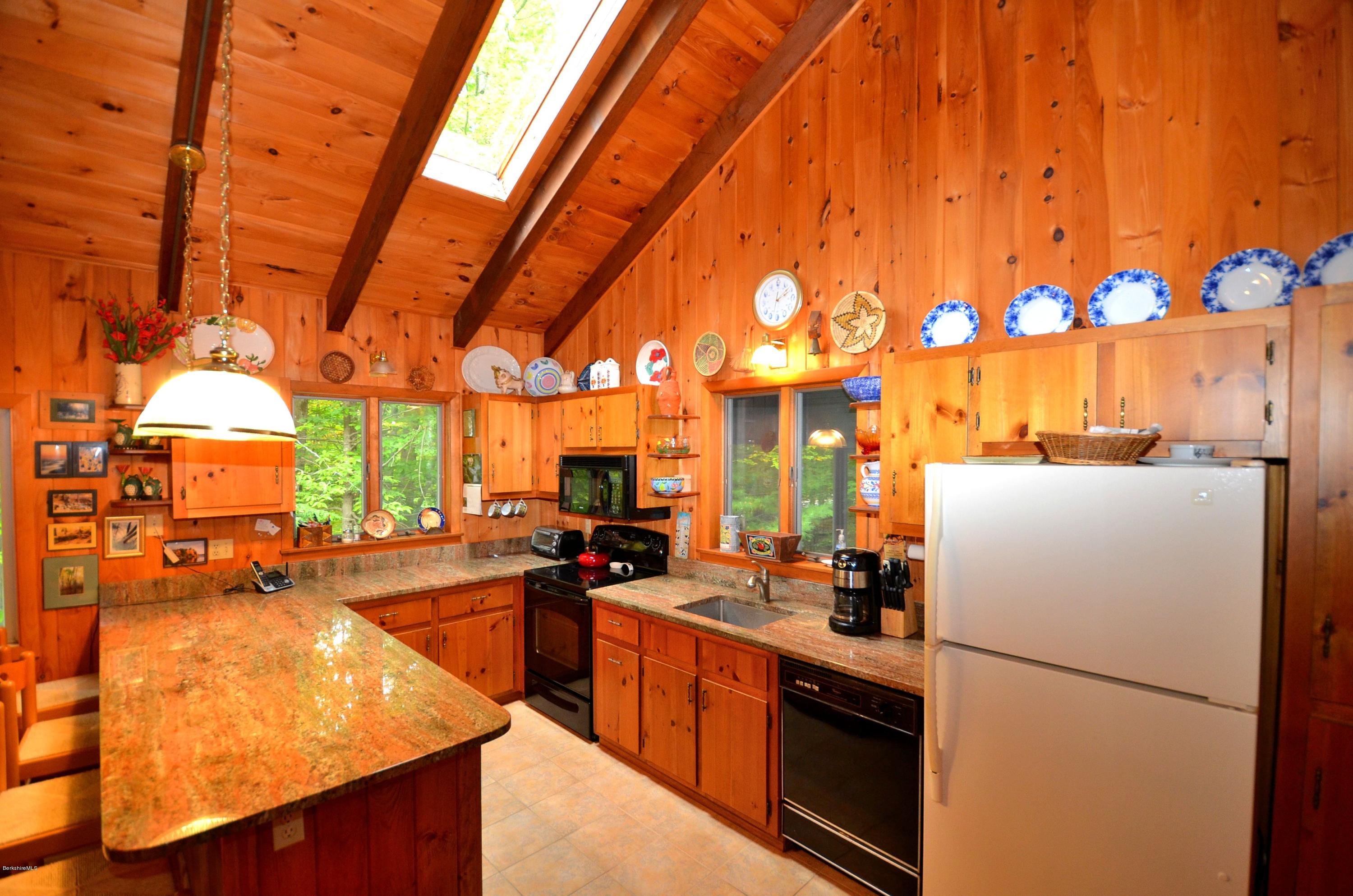 19 Cherokee Road Becket, MA 01223 - Photo 11 of 22 a kitchen with refrigerator and cabinets