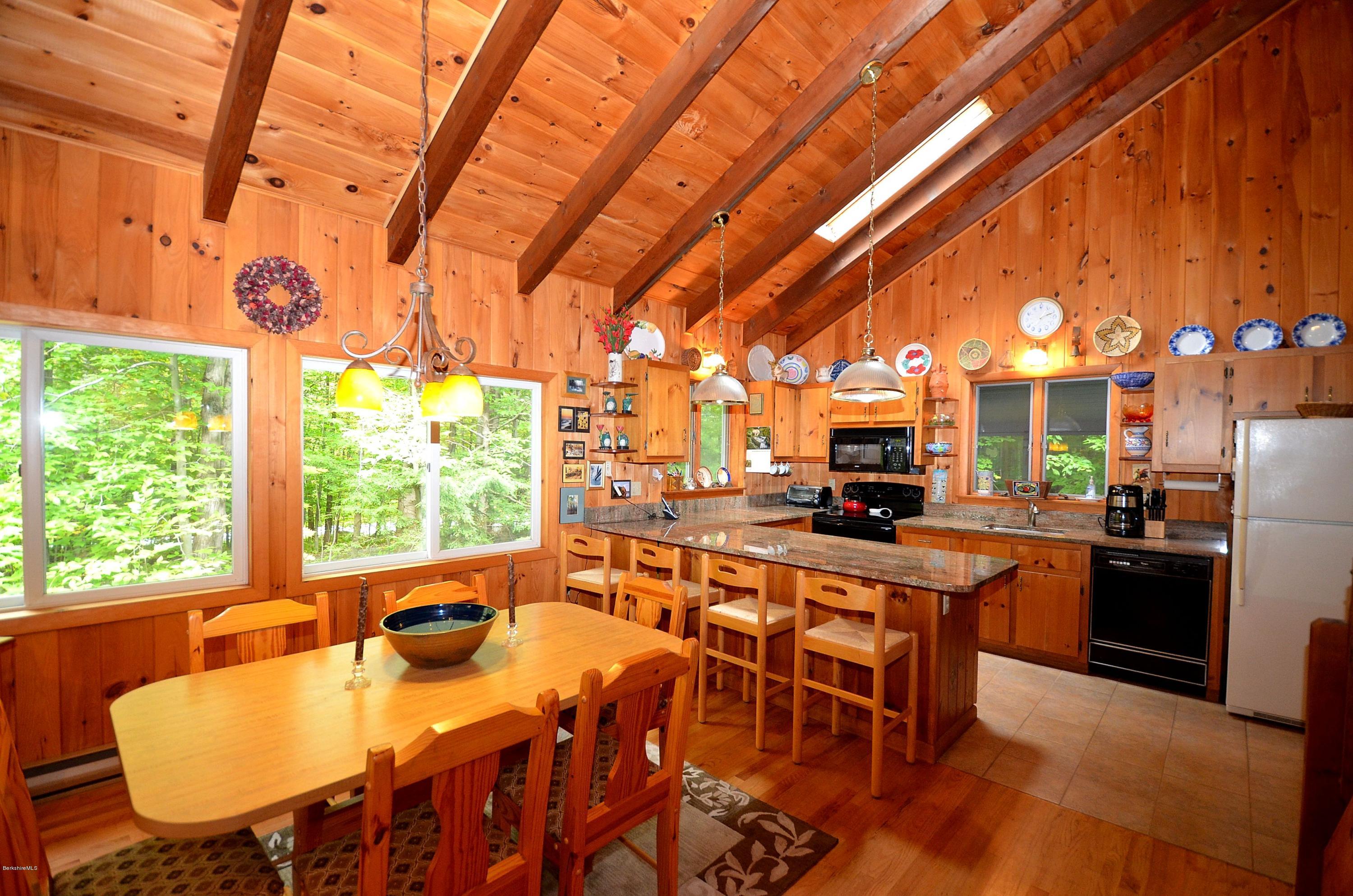 19 Cherokee Road Becket, MA 01223 - Photo 14 of 22 a view of a dining room with furniture window and outside view