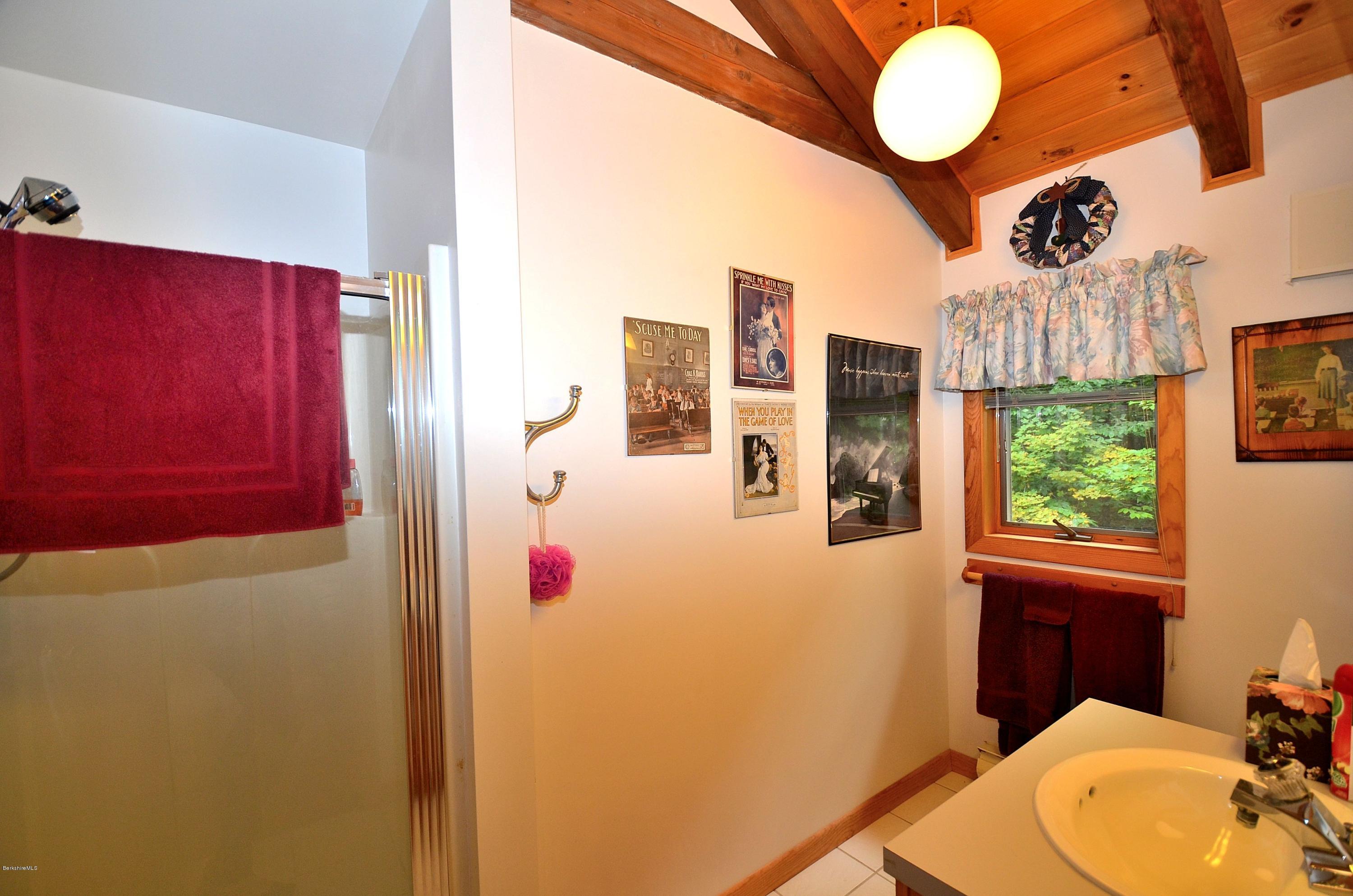 19 Cherokee Road Becket, MA 01223 - Photo 15 of 22 a bathroom with a sink a toilet and shower curtain