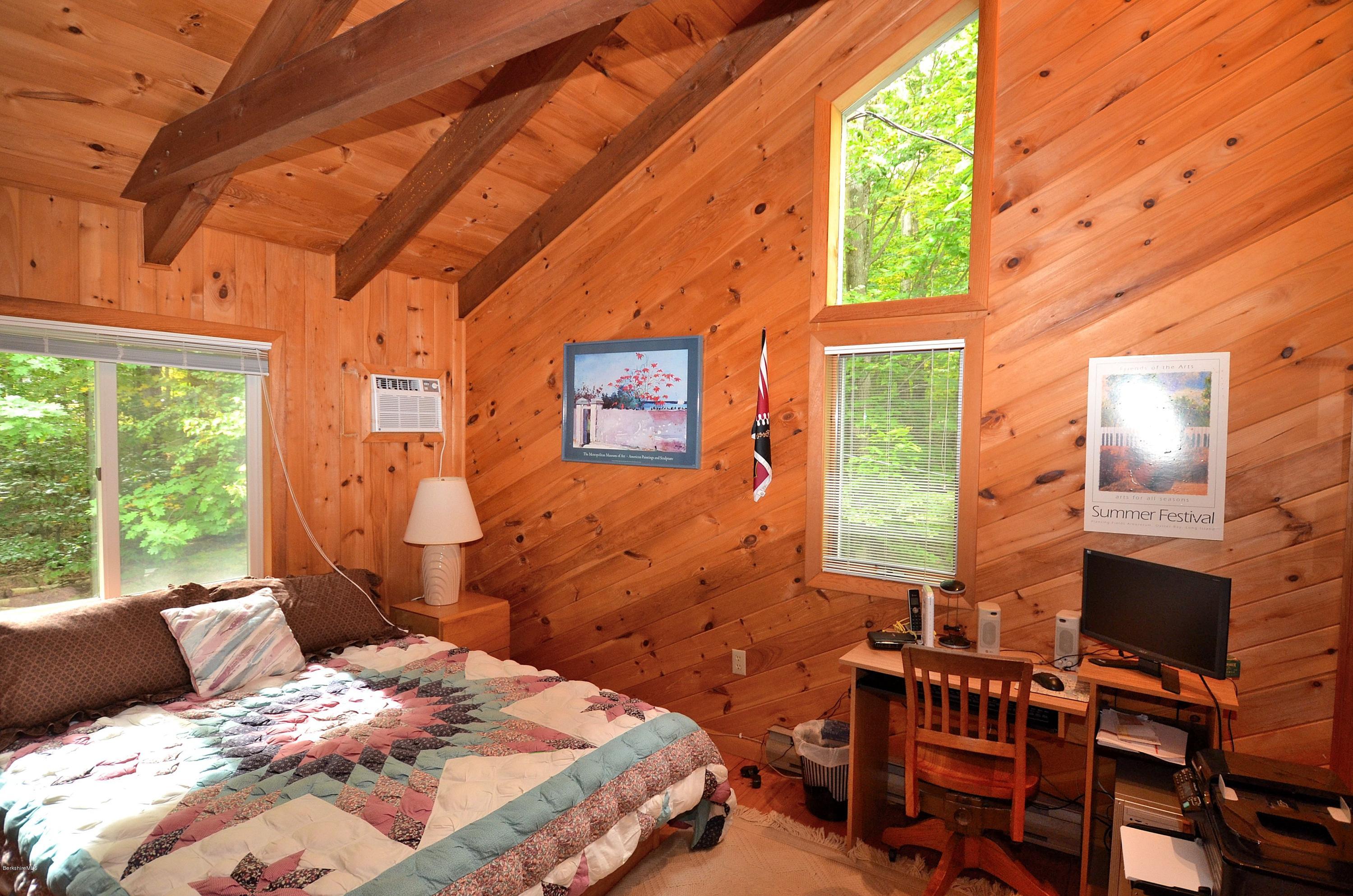 19 Cherokee Road Becket, MA 01223 - Photo 16 of 22 a bedroom with a bed wooden floor and a window