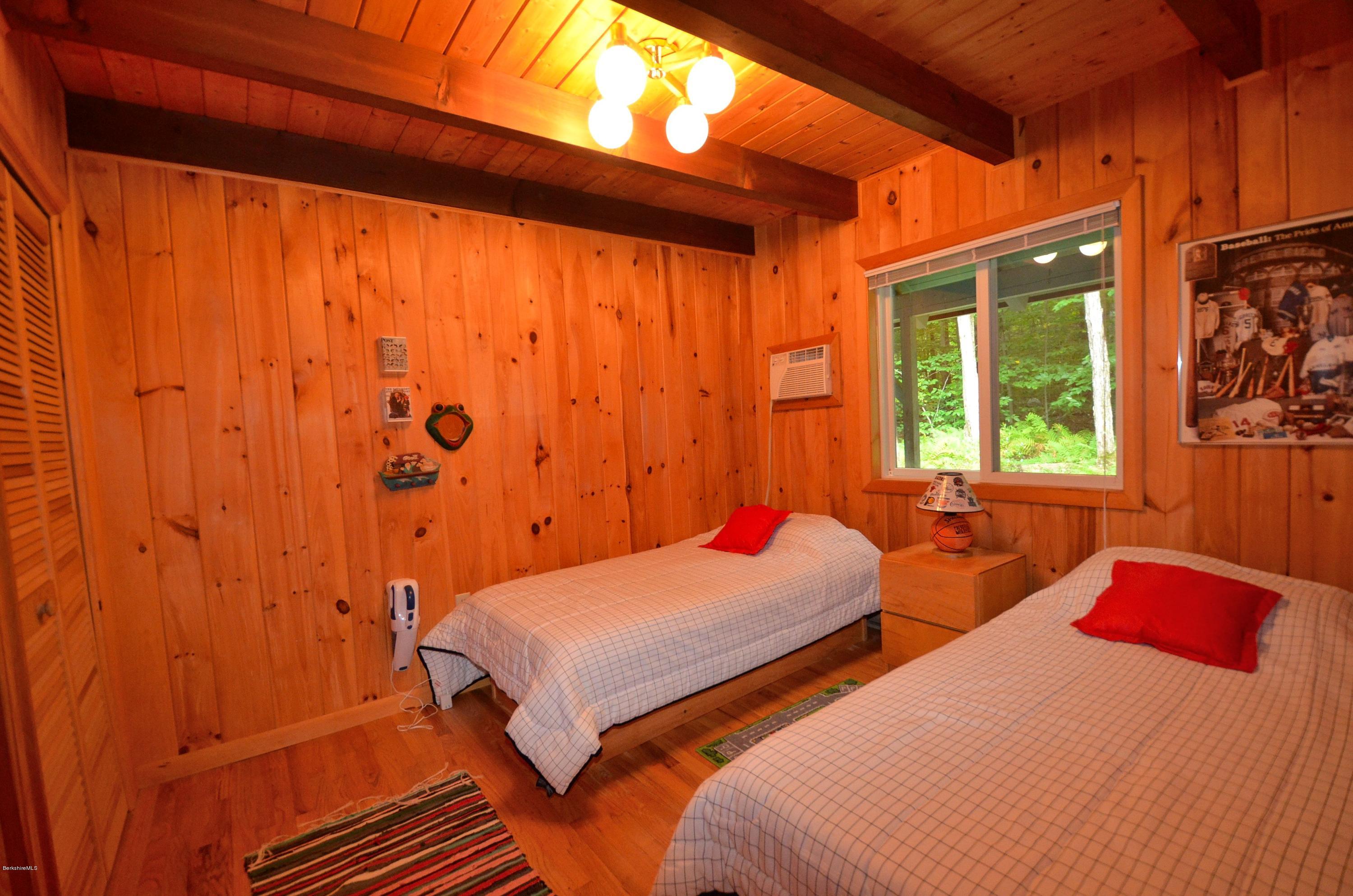 19 Cherokee Road Becket, MA 01223 - Photo 3 of 22 a bedroom with two beds and a window