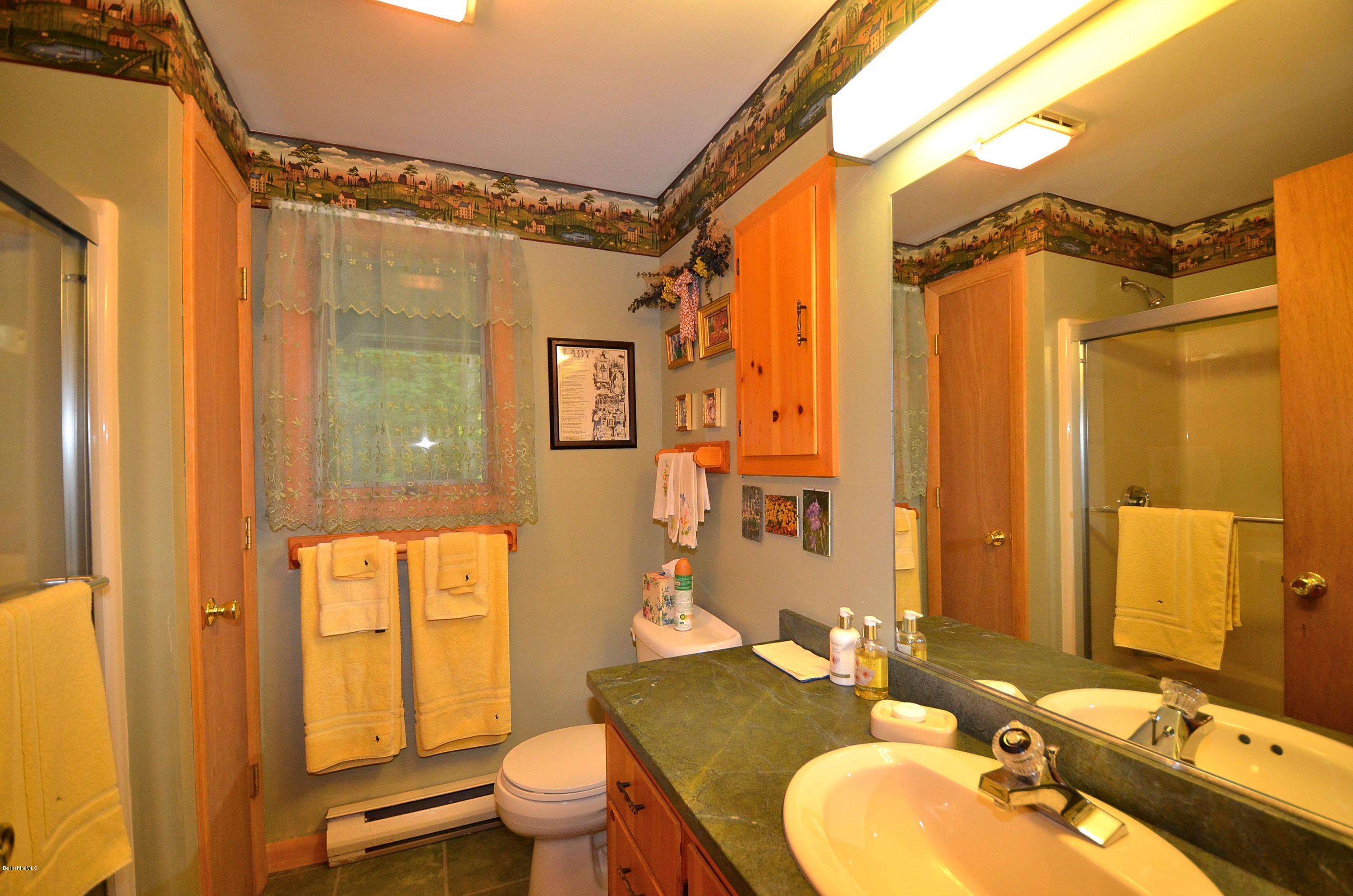 19 Cherokee Road Becket, MA 01223 - Photo 5 of 22 a bathroom with a granite countertop sink toilet and shower
