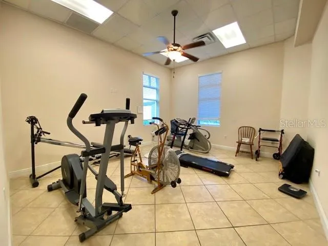a room with gym equipment and view of living room