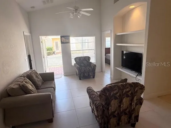 a living room with furniture and a flat screen tv