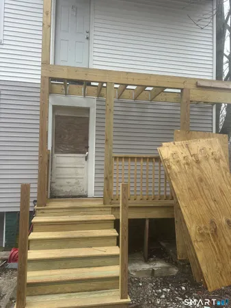 a view of a small house with a yard