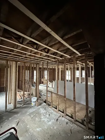 a view of a hall with wooden floor and furniture