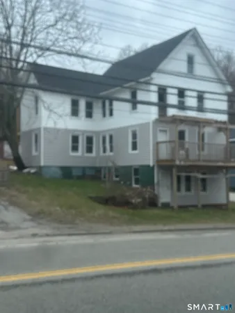 a view of a big house with a street