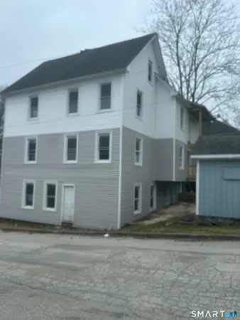 a view of a white house with large windows