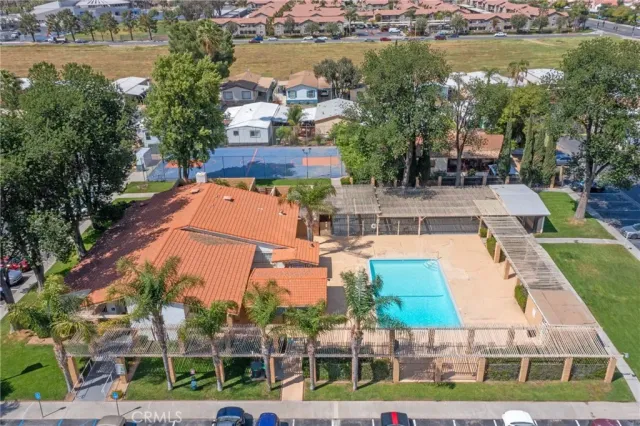 an aerial view of residential houses with outdoor space and lake view
