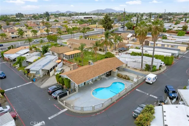 an aerial view of residential houses with outdoor space and parking