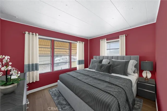 a bedroom with a bed and a potted plant