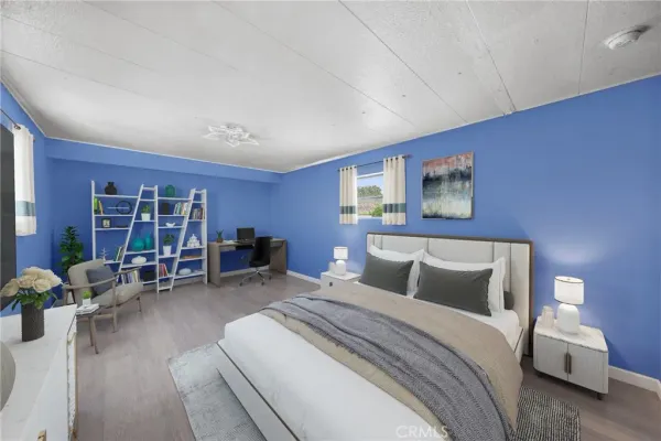 a bedroom with a bed and a large window