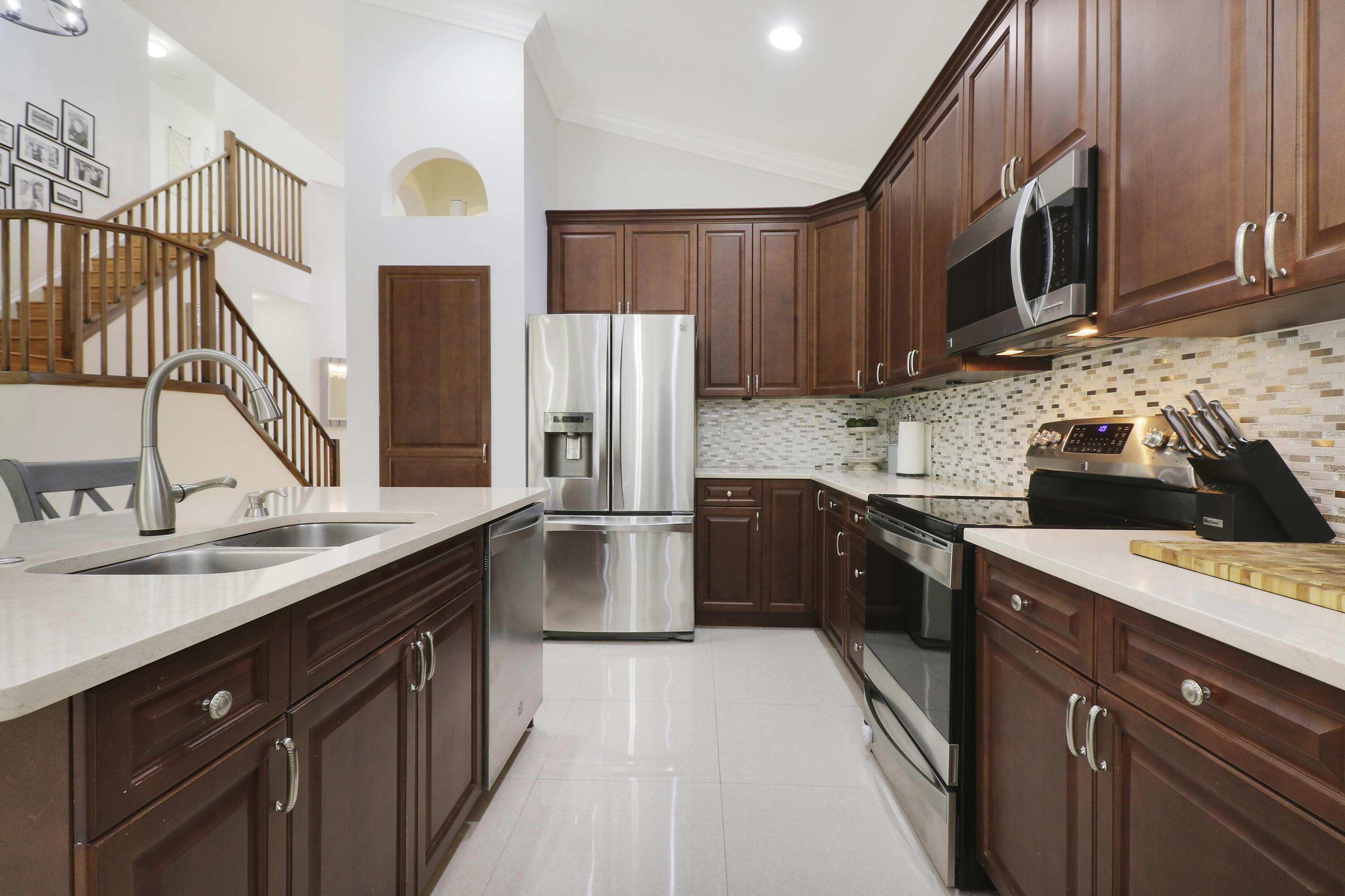 211 Pennock Trace Drive Jupiter, FL 33458 - Photo 8 of 39 a kitchen with stainless steel appliances granite countertop a sink stove and refrigerator