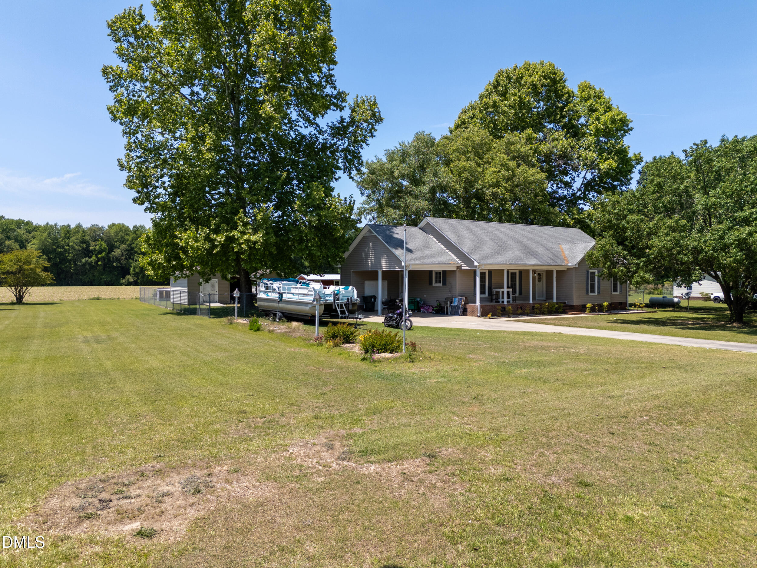 311 Bridgers Road Kenly, NC 27542 - Photo 3 of 46 a front view of a house with swimming pool and a yard