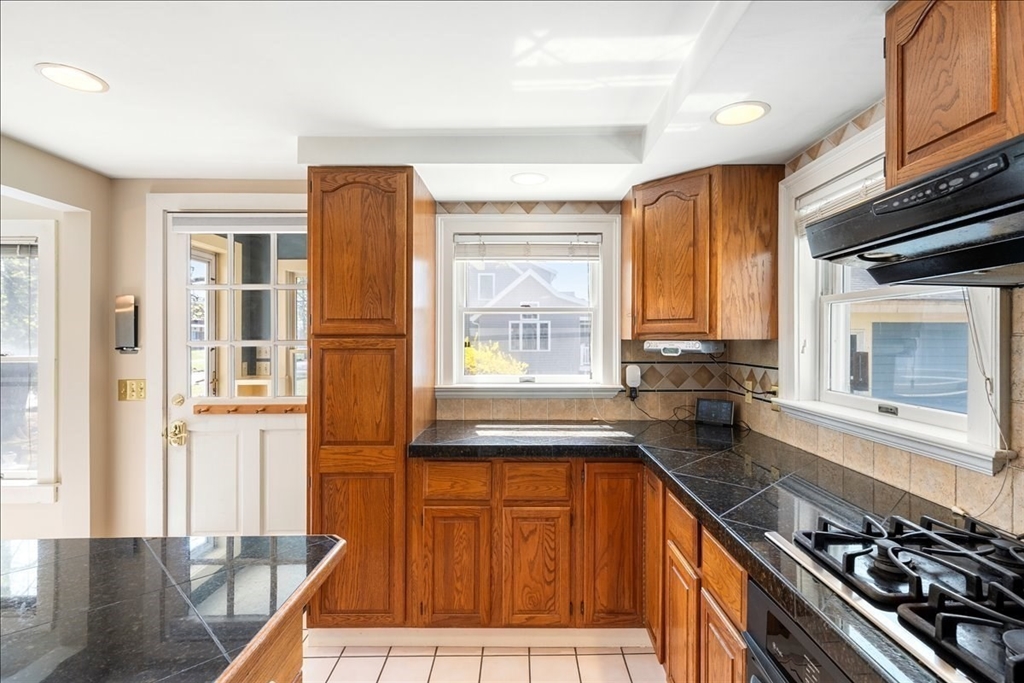 10 2nd Street Natick, MA 01760 - Photo 8 of 31 a kitchen with stainless steel appliances granite countertop a stove a sink and a microwave