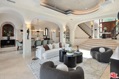 a view of a dining room with furniture and chandelier