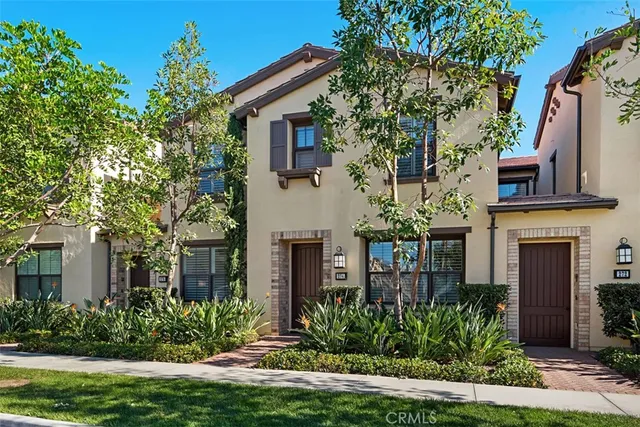 a front view of a house with a yard garage and outdoor seating