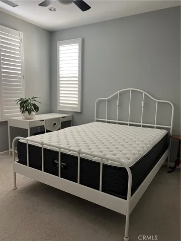 a spacious bedroom with a bed and window