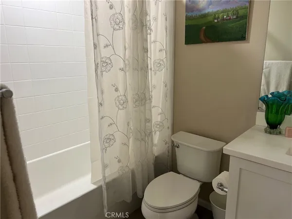 a white toilet sitting next to a shower