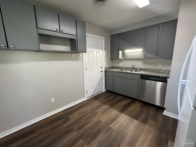 a kitchen with wooden cabinets and white appliances
