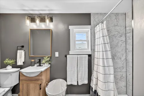 a bathroom with a sink toilet and shower