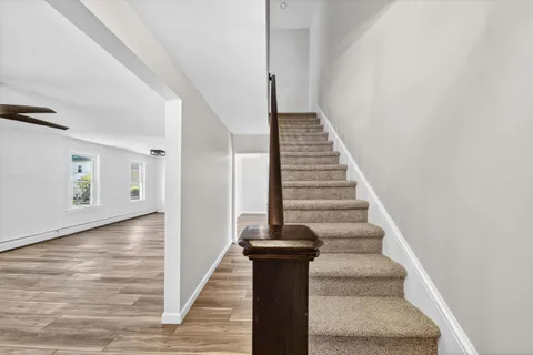 a view of entryway and hall with wooden floor