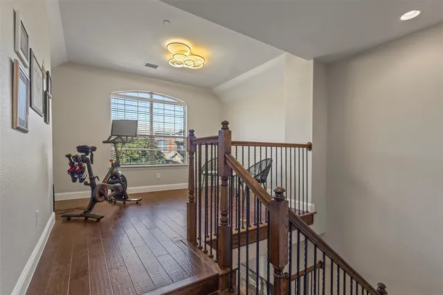 a view of a room with wooden floor and windows