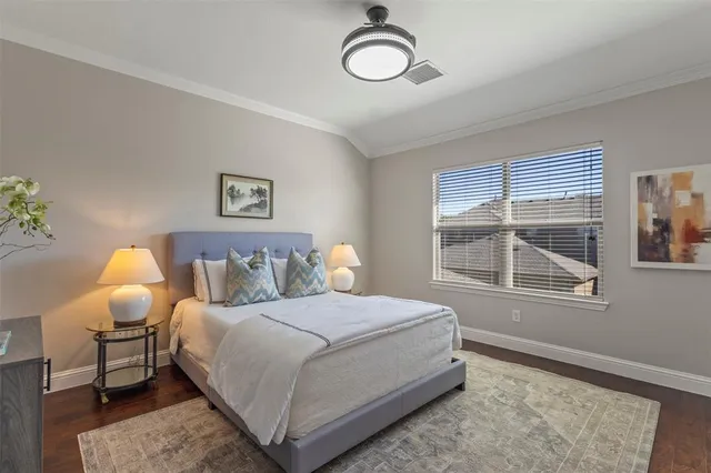 a bedroom with a bed lamp and a window